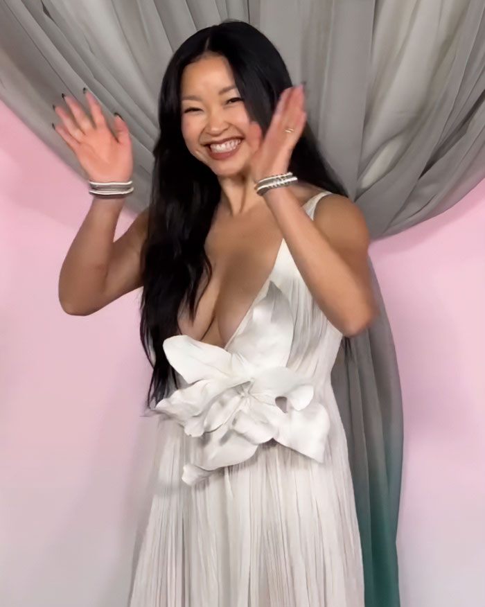 Lana Condor smiling and waving, wearing a bold white dress that sparked body shaming debate on the red carpet. Lana Condor smiling and waving, wearing a bold white dress that sparked body shaming debate on the red carpet.