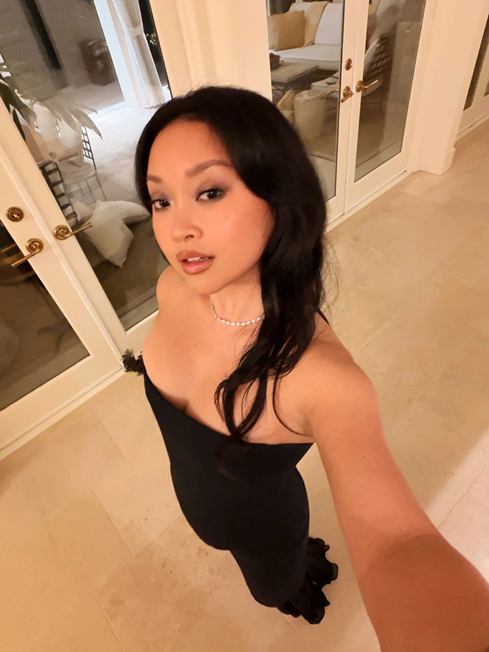 Lana Condor taking a selfie in a black dress at home, highlighting her bold choice on award show red carpet amid debate. Lana Condor taking a selfie in a black dress at home, highlighting her bold choice on award show red carpet amid debate.