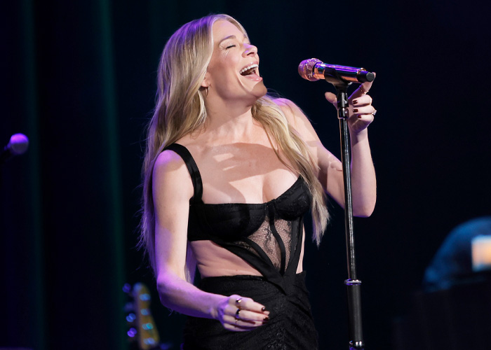LeAnn Rimes smiling and singing on stage, linked to experts discussing emotional response to jaw release therapy.