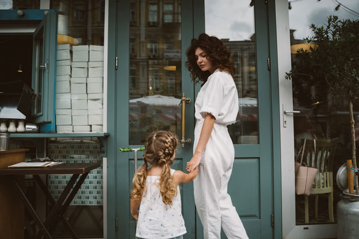 Man forced to change locks holding daughter's hand outside a closed door, reflecting family conflict and protection concerns.