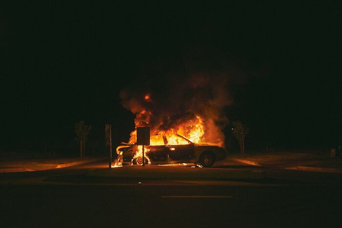 Car engulfed in flames at night, illustrating one of the most unexpected and bizarre ways people passed away.