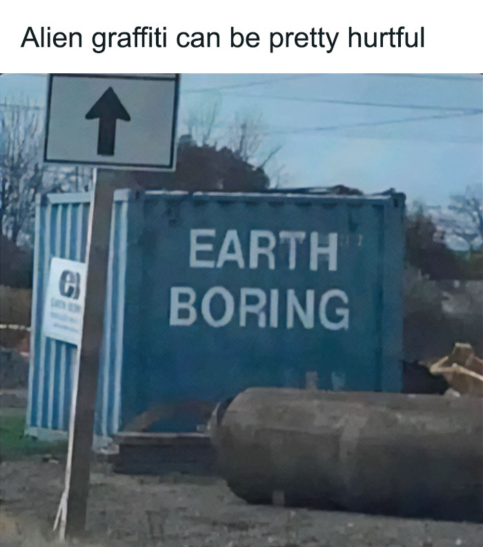 Graffiti on a container reading Earth Boring with a signpost and outdoor industrial setting, a lighthearted safe-for-work meme.
