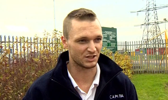 Man wearing a black Capita jacket speaking outdoors near a fence and power lines, related to historical mistakes and consequences.