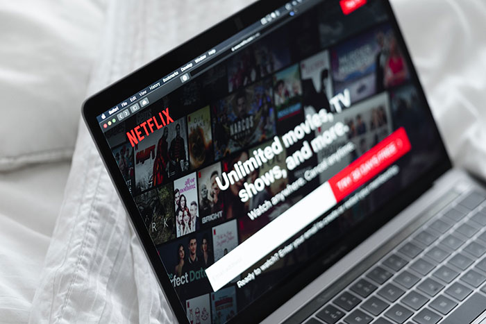 Laptop screen displaying Netflix homepage with movies and shows, illustrating a costly historical mistake in entertainment history.