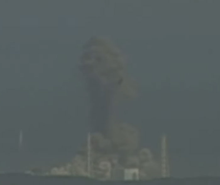 Explosion with huge smoke cloud rising from industrial site, illustrating historical mistakes with massive consequences and expenses.