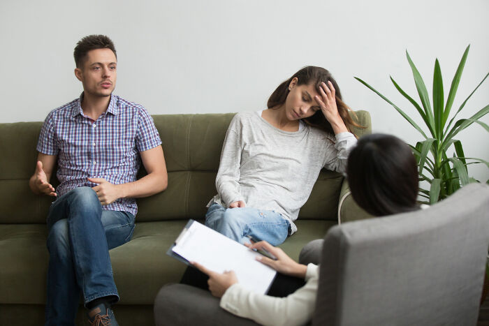 A couple in therapy, man speaking, woman looks distressed. Addressing how diagnosed narcissists leave a mark on everyone.