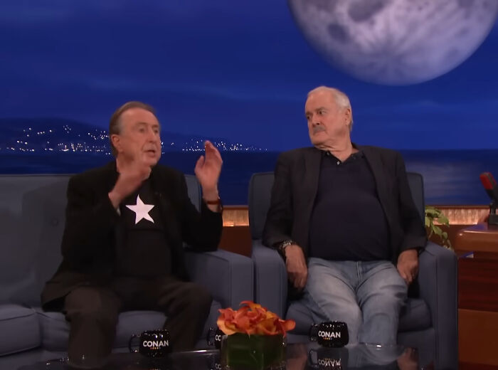 Two male celebrities on a talk show, one gesturing animatedly, the other listening. Highlighting rudest celebs stories.