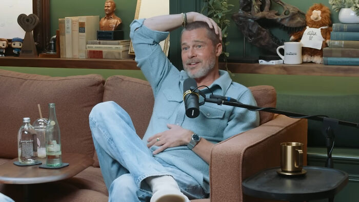 Brad Pitt sits on a couch, running his hand through his hair, looking surprised. A main rude celeb example.