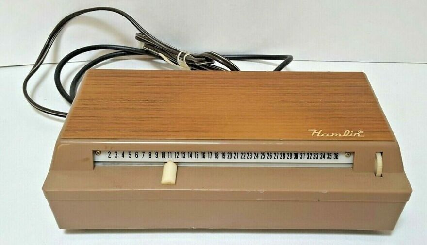 A vintage Hamlin cable box, wood grain top, brown plastic base with tuning slider, evoking a trip down memory lane.