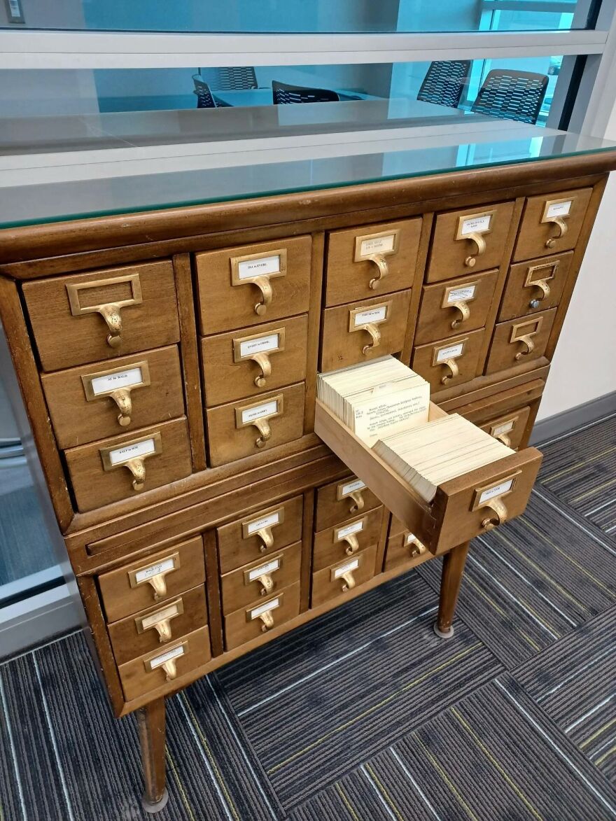 A vintage library card catalog with many drawers, one pulled open to show index cards. A trip down memory lane.