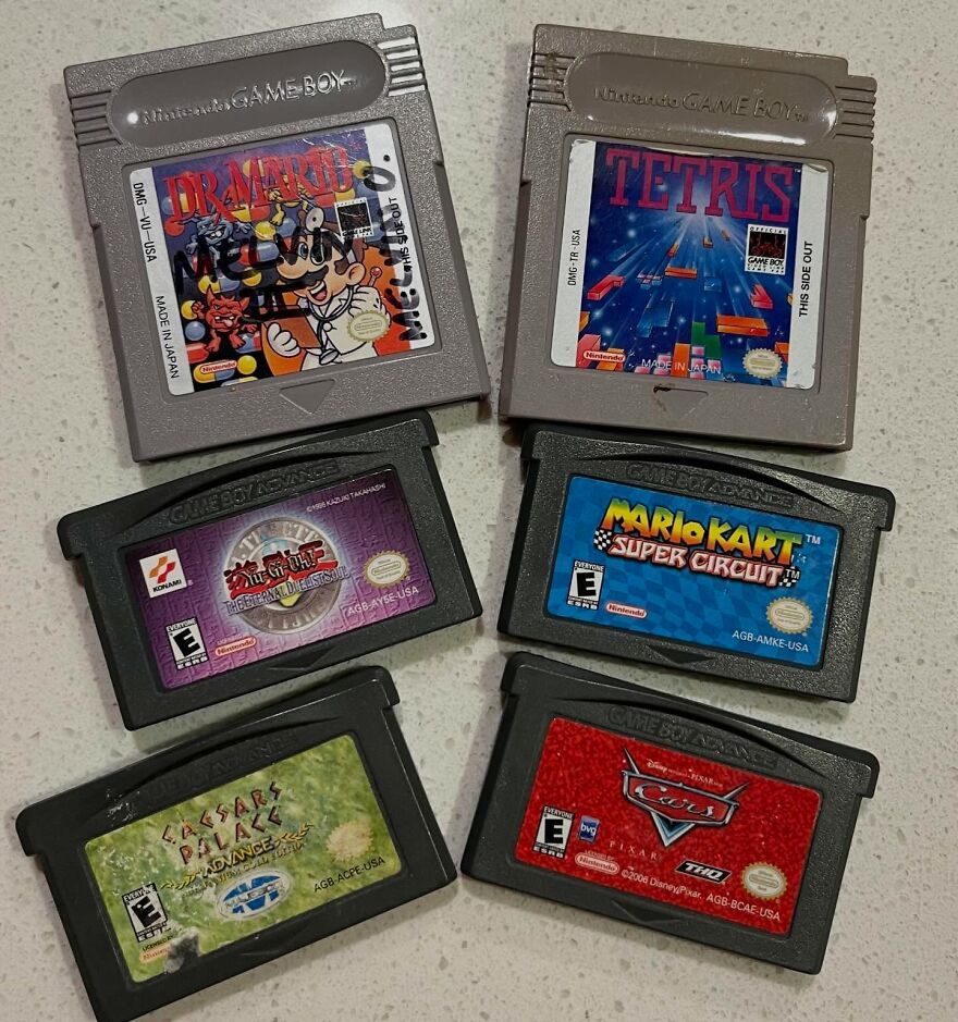 A collection of classic Game Boy and Game Boy Advance cartridges including Tetris and Mario Kart, taking a trip down memory lane.