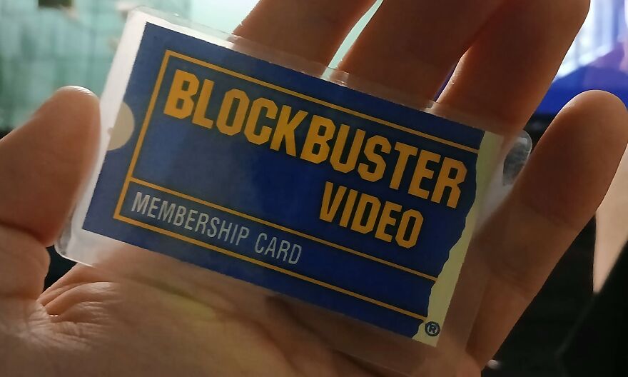 A hand holding a Blockbuster Video membership card. This photo will take you down memory lane.