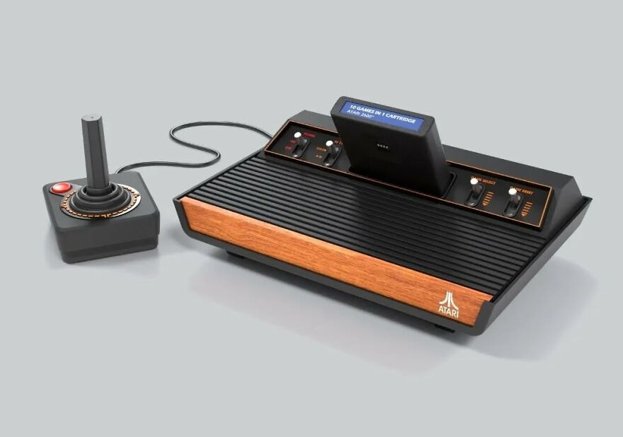 An Atari 2600 console with a joystick and a game cartridge inserted, taking a trip down memory lane.