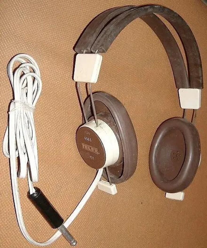 Old brown and white Telex headphones with a coiled white cord, sparking a trip down memory lane.