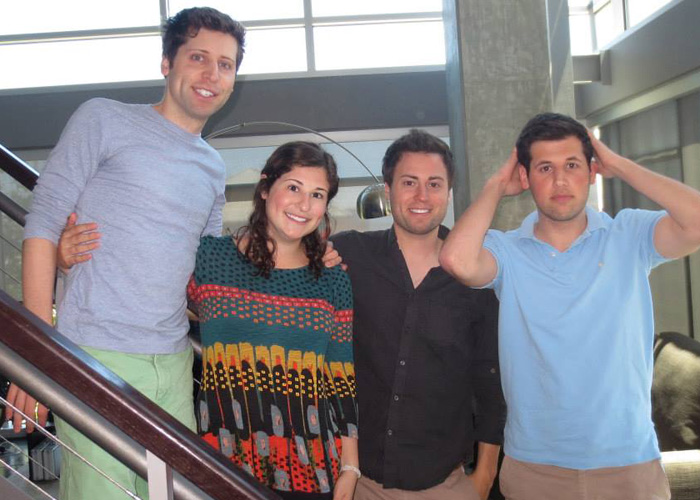 Group photo of four young adults indoors, highlighting OpenAI CEO Sam Altman amid family and friends.