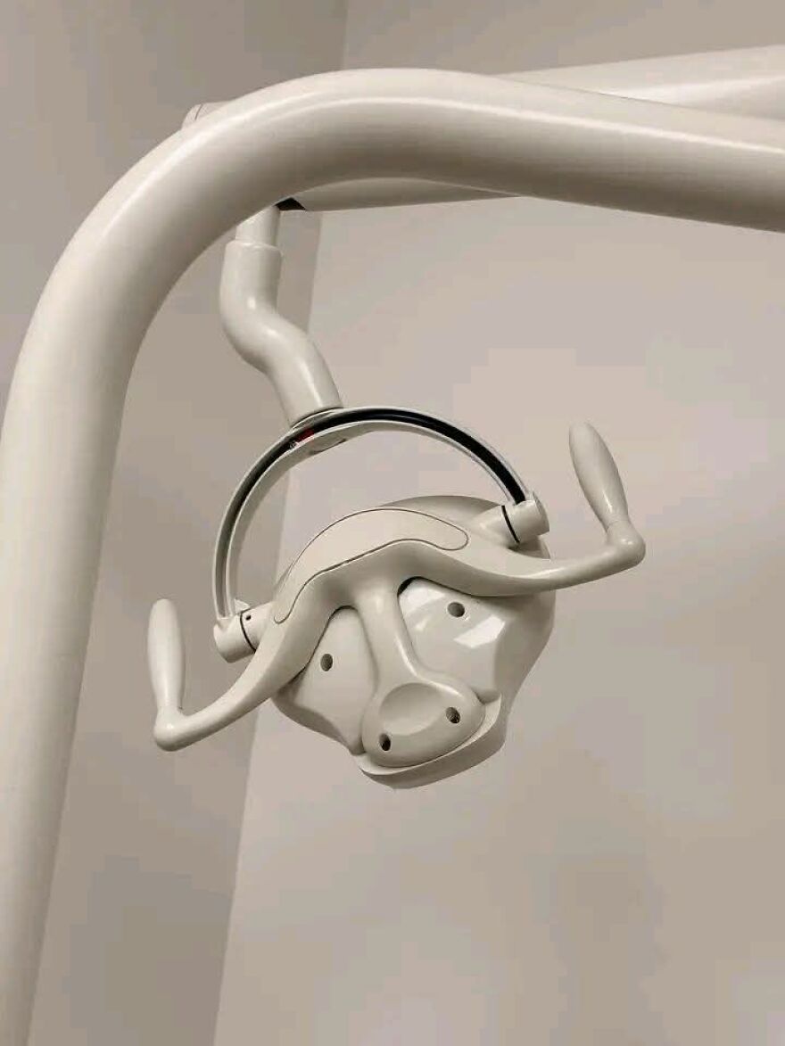 Dental lamp resembling a face showing pareidolia effect with handles looking like eyes and nose in a close-up shot.