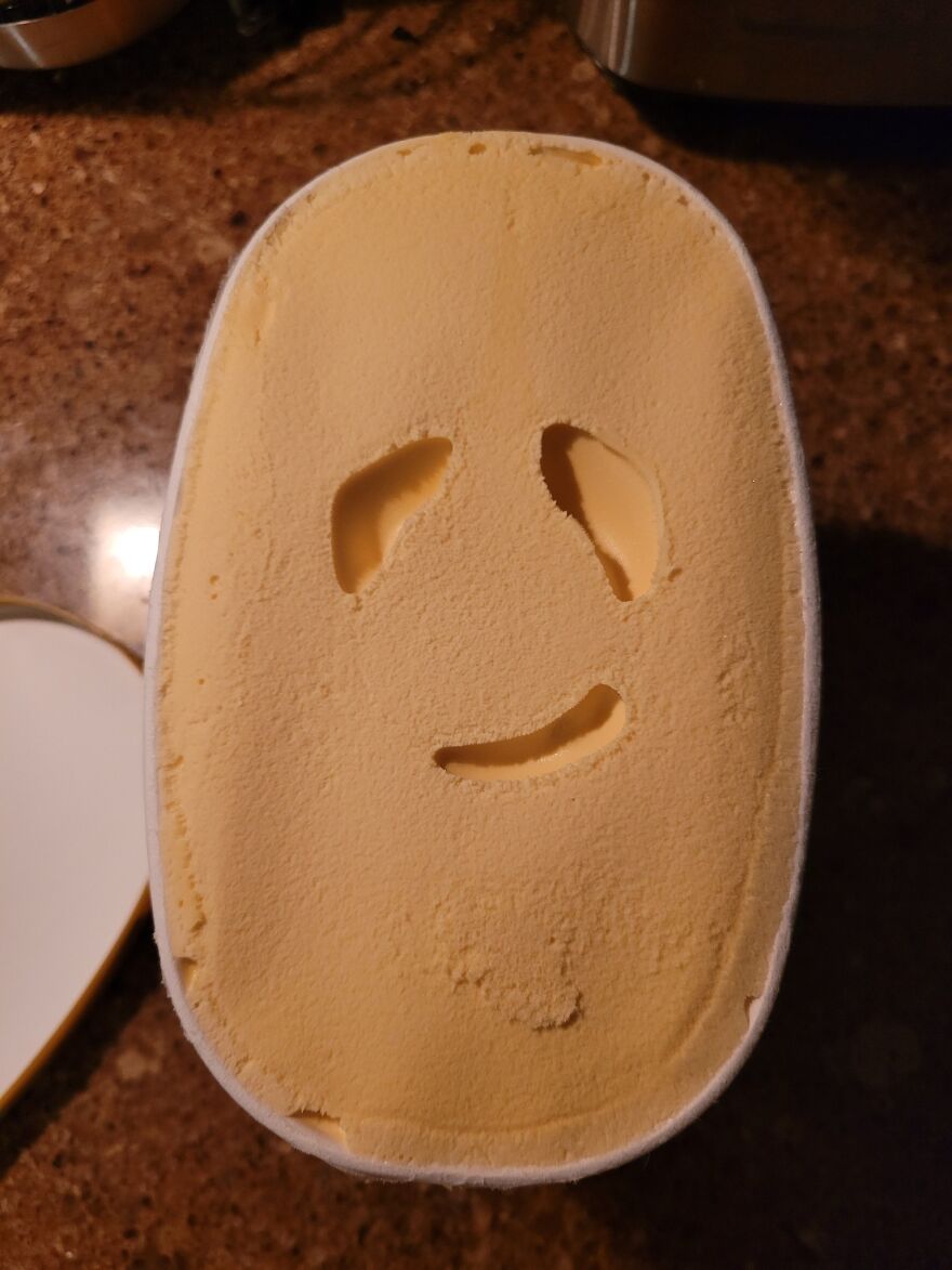Ice cream surface showing pareidolia with face-like pattern resembling eyes and a smiling mouth.