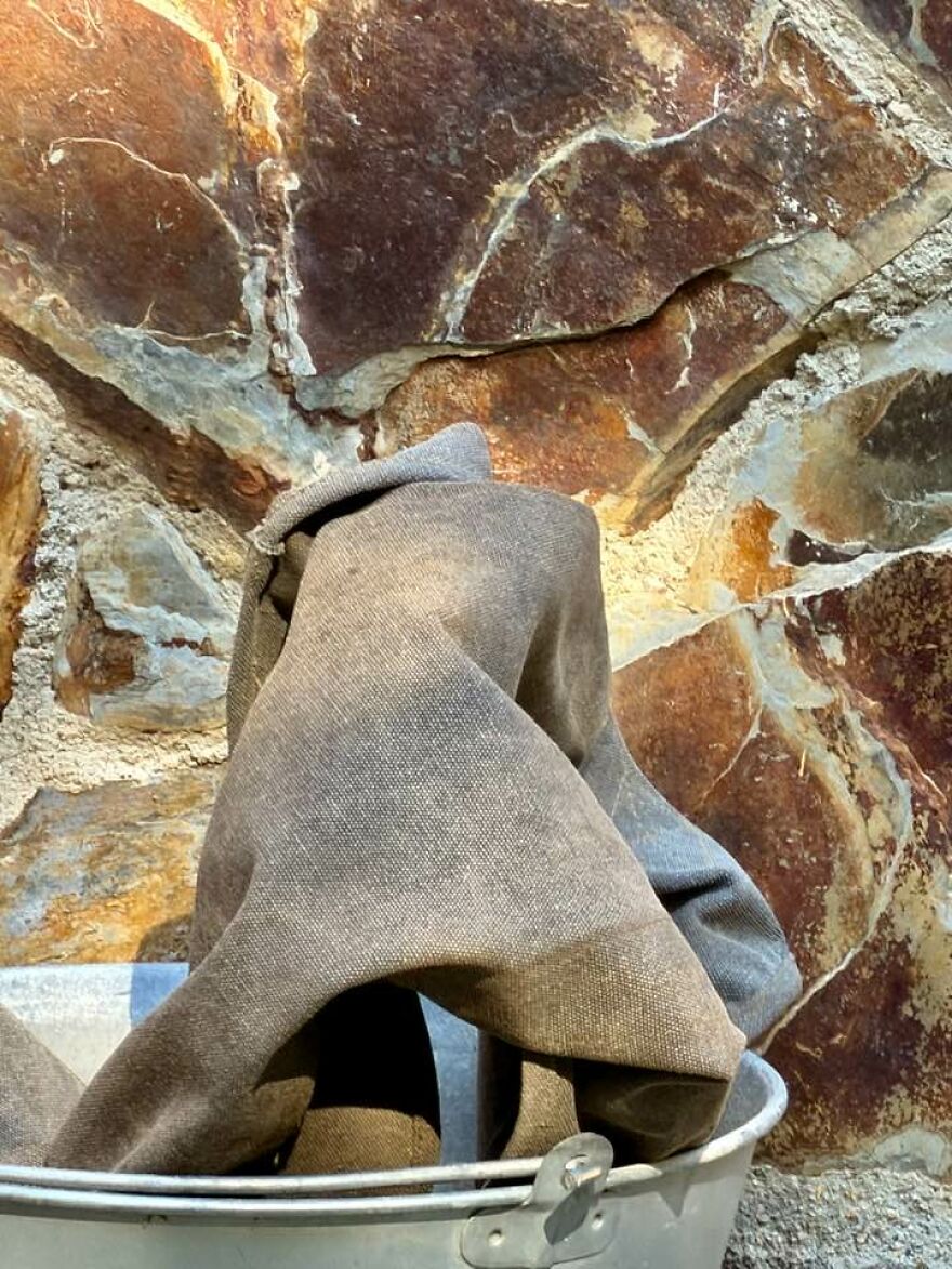 Cloth draped over a bucket resembling a ghostly figure, showcasing a unique pareidolia moment in everyday objects.