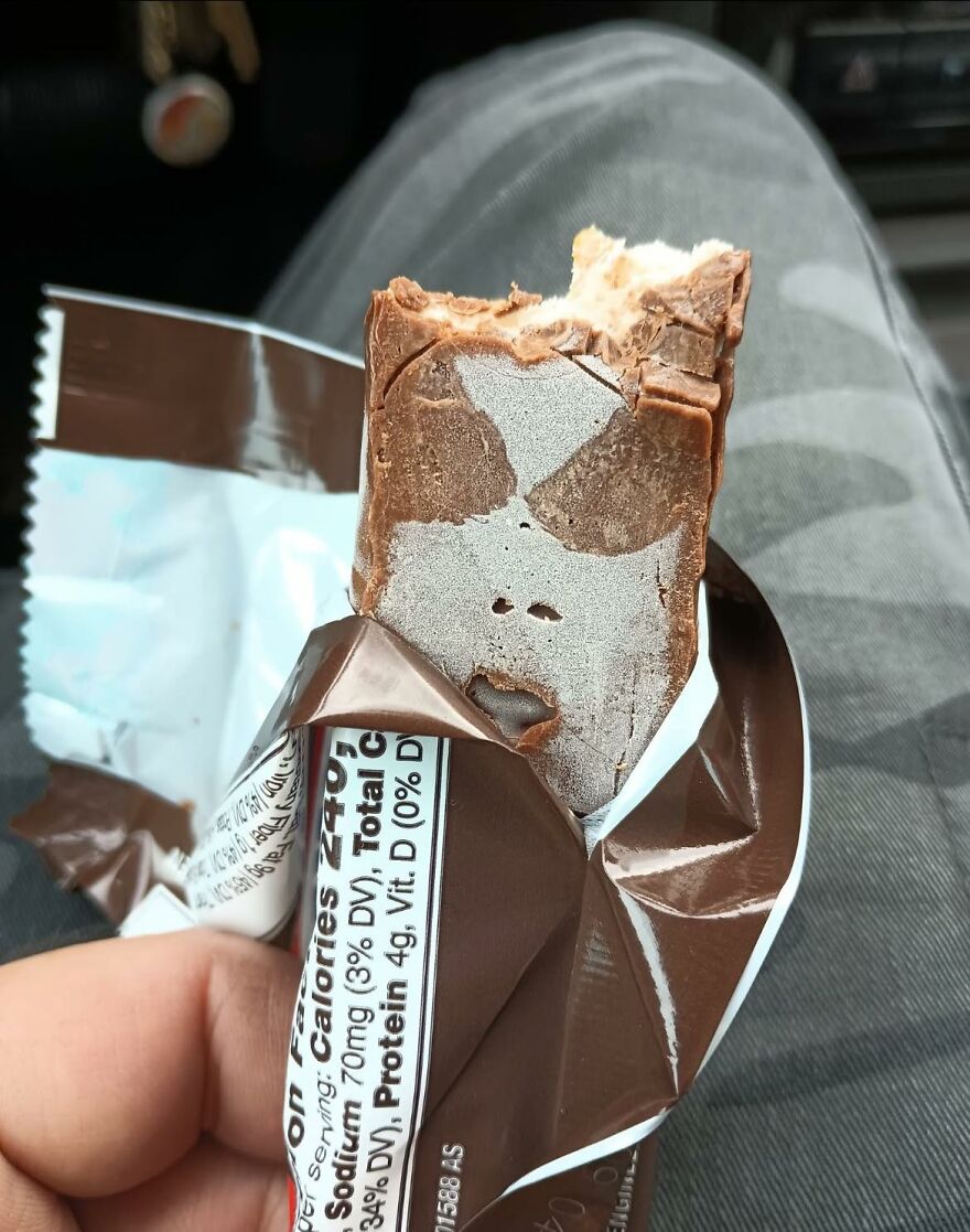 Partially eaten chocolate bar showing a face-like pattern illustrating pareidolia in everyday objects.