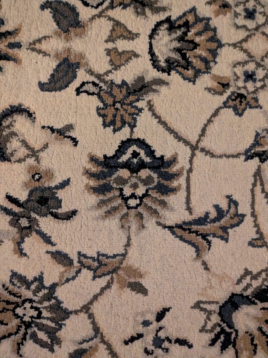 Abstract carpet pattern resembling a face, an example of pareidolia captured in a detailed close-up image.