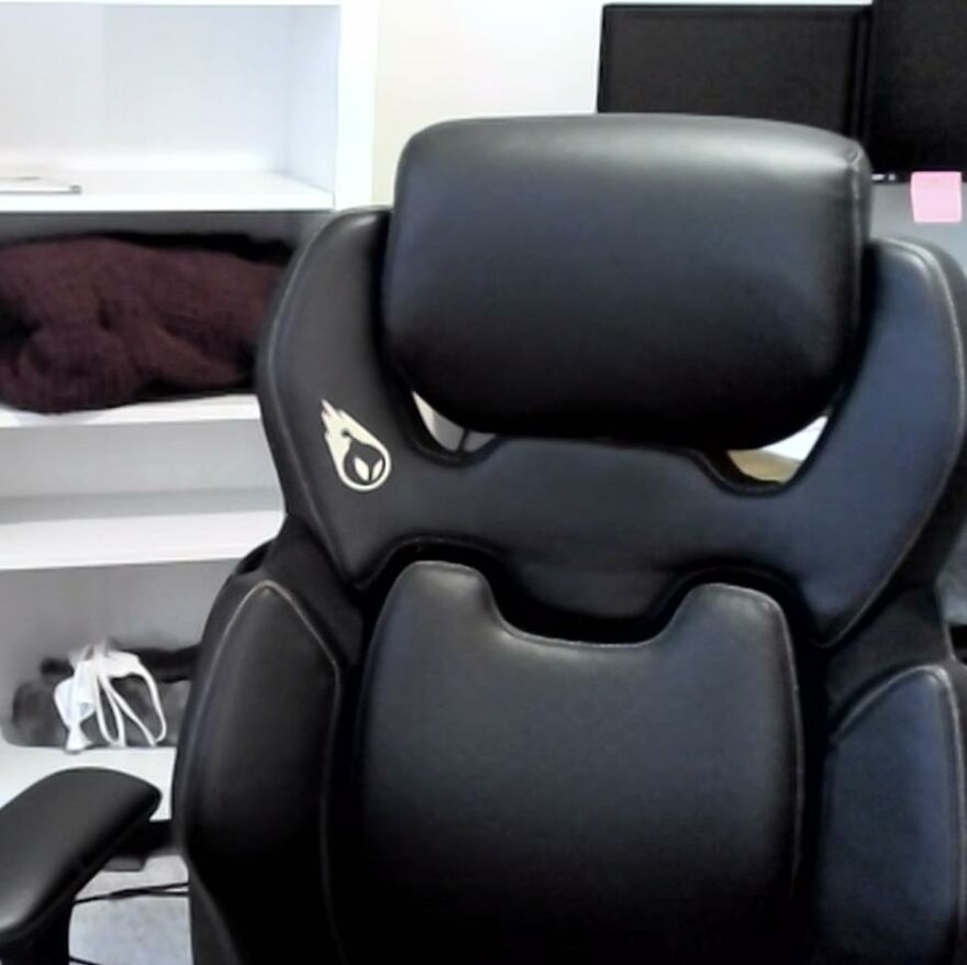 Black leather chair with a design resembling a face, an example of pareidolia in everyday objects.