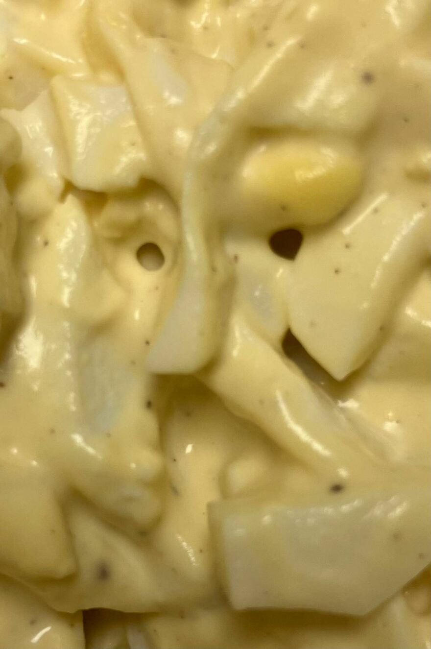 Close-up of a creamy dish with shapes resembling a face, illustrating pareidolia in everyday objects.