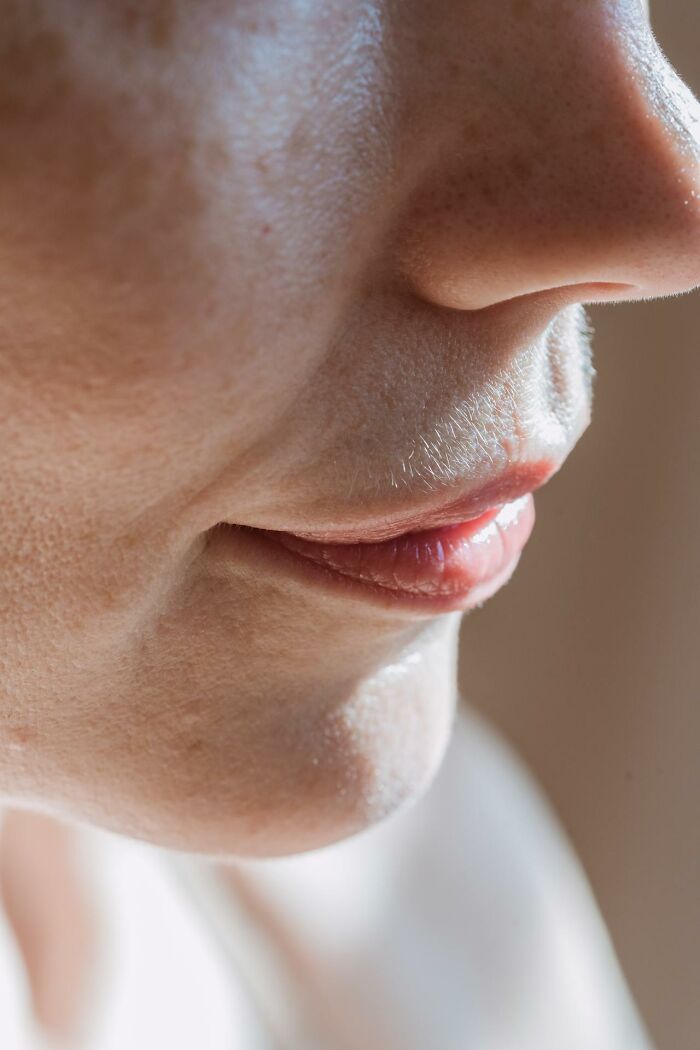 Close-up of a person's lower face showing skin texture and lip details related to weird and interesting medical facts.
