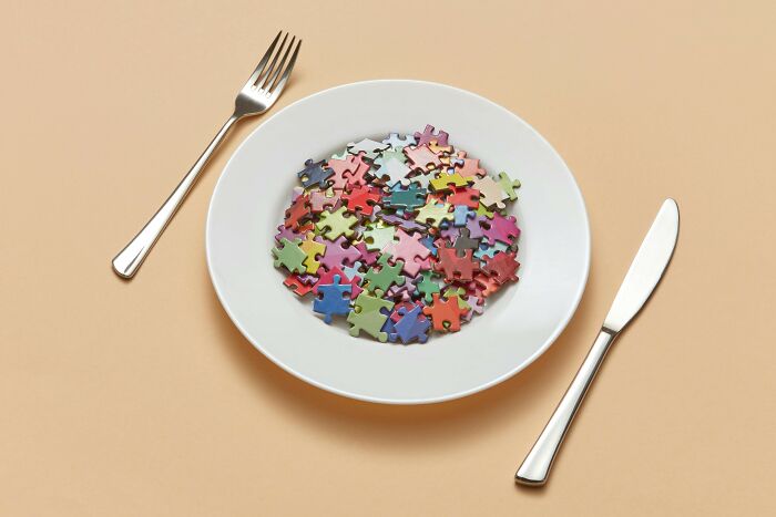 A white plate filled with colorful puzzle pieces, symbolizing a cognitive ability test and logical deduction skills.