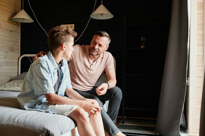 A father comforting his son while sharing family secrets, a moment that will shake them to the core.