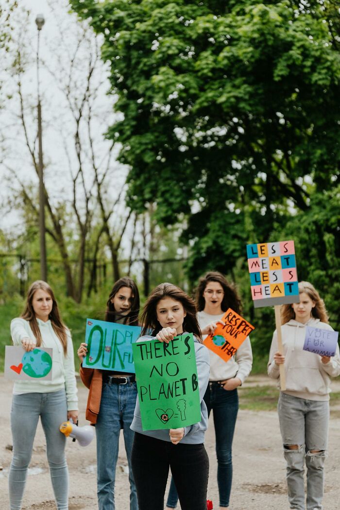 Group of young people holding protest signs about the environment, illustrating terrifying statistics that might make it hard to sleep.