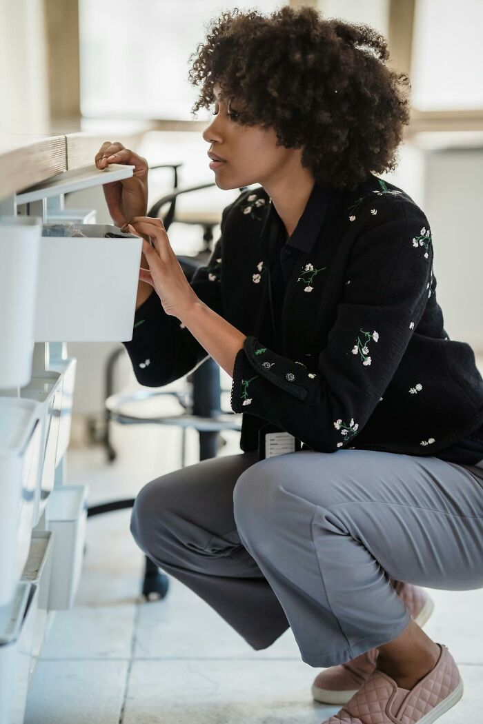 Woman checking drawer in office, illustrating people seeing their intuition proved right in everyday situations.