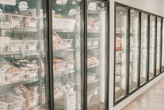 Freezer section in a store showing frozen food products behind glass doors, illustrating wild times employees quitting jobs.