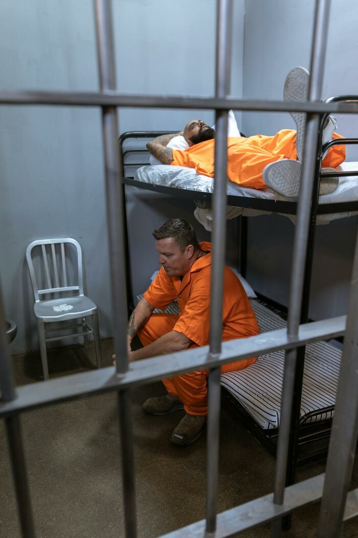 Two prisoners in orange uniforms in a jail cell, illustrating terrifying statistics that might make it hard to sleep tonight.