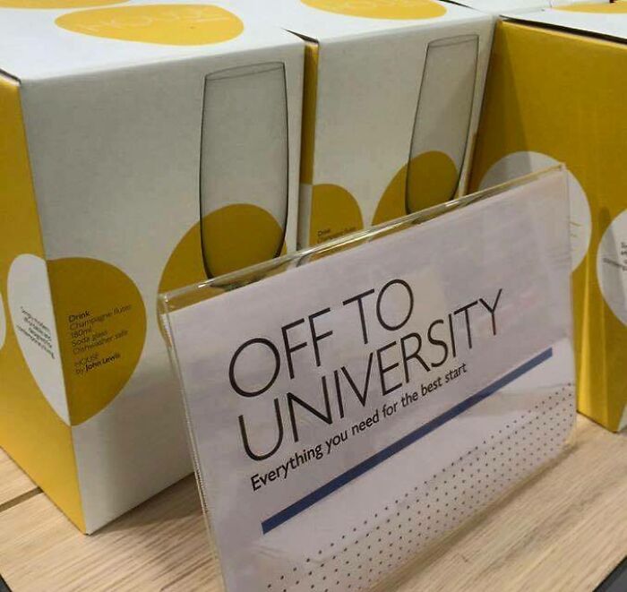 A sign reading Off to University in front of champagne flutes, a humorous British meme for student life.