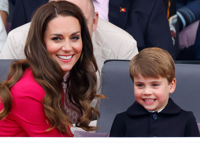 Prince Louis smiling, seated next to Kate Middleton, both look happy. A family comparison for his birthday portrait.