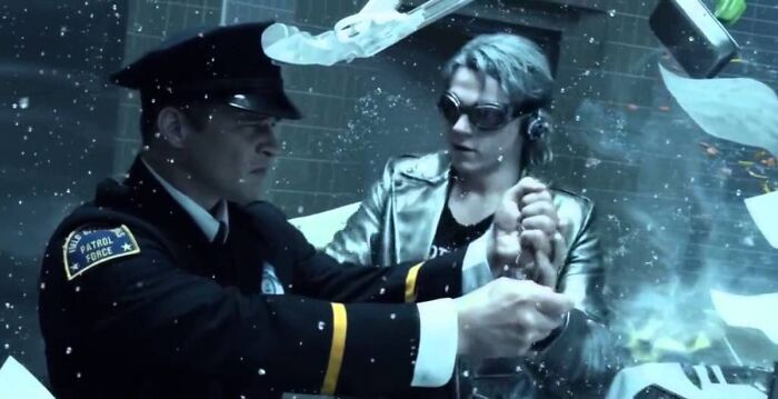 A-Train restrained by a patrol officer amid shattered glass, highlighting The Boys season 5 fate in a dramatic scene.