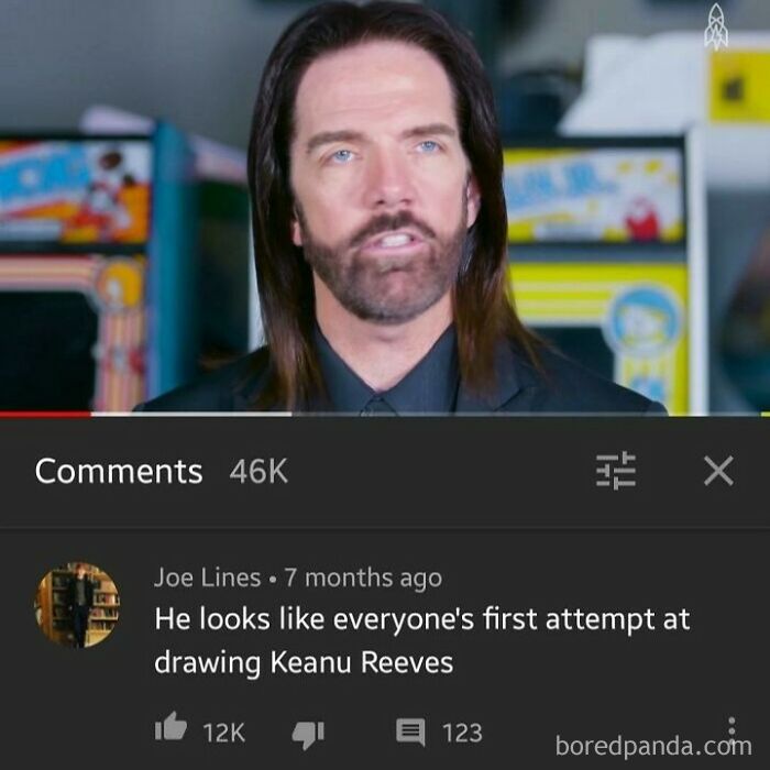 A man with long dark hair and a beard, resembling Keanu Reeves, receiving a rare burn in a YouTube comment.