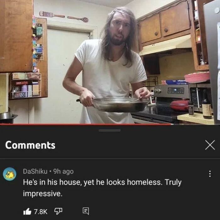 A man with long hair in a kitchen, holding a frying pan. A comment below says he looks homeless. Rare Burns.