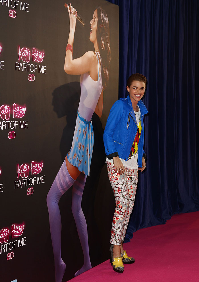 Former club manager at event with promotional Katy Perry Part of Me 3D backdrop, smiling and wearing colorful outfit. Former club manager at event with promotional Katy Perry Part of Me 3D backdrop, smiling and wearing colorful outfit.
