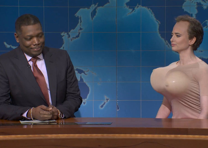 SNL skit mocks Kristi Noem's husband Bryan with exaggerated props during a comedic segment on a news parody show.