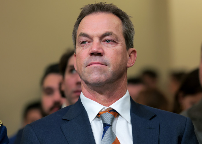 Bryan Noem in a suit and tie attending an indoor event as SNL faces backlash for mocking him over scandal.