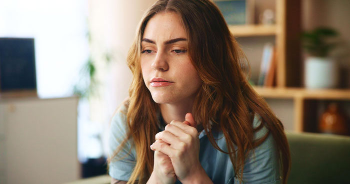 Pregnant woman looking concerned indoors, reflecting on unstable ex and sister-in-law feeding information issues.