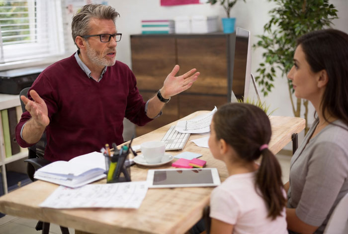 Parent and daughter meeting with school official about daughter’s fear of snakes and possible suspension concerns. Parent and daughter meeting with school official about daughter’s fear of snakes and possible suspension concerns.