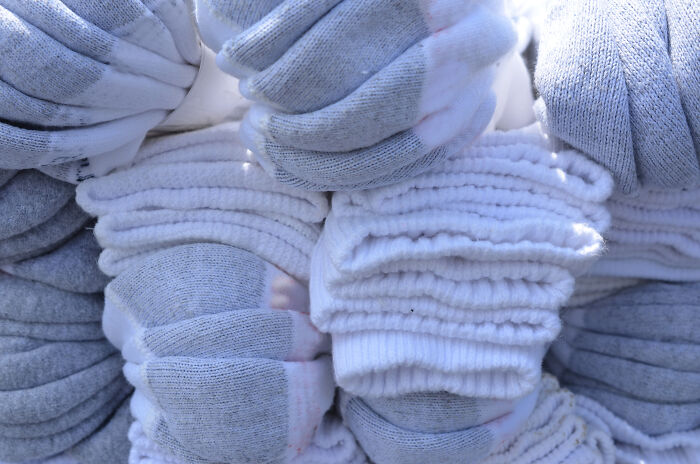 Stacks of neatly folded white and gray socks, a visual representation of everyday adult life organization.