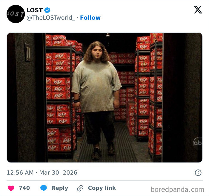 Man standing in a room full of KitKat bars, related to the stolen KitKat tracker campaign by the brand.