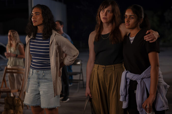 Three characters from The Pitt Season 3 standing together outdoors at night during an intense moment.