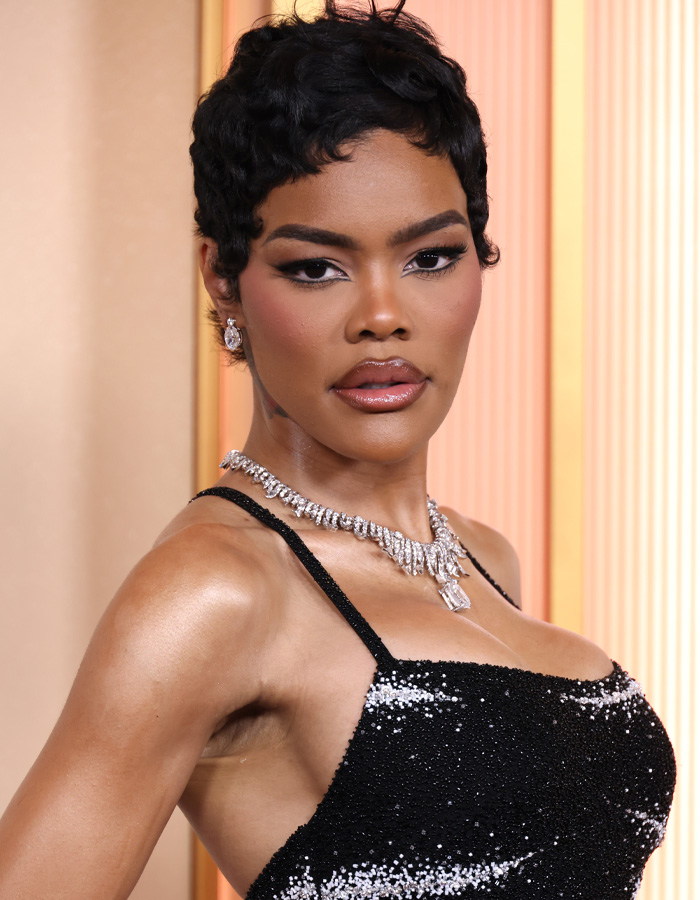Teyana Taylor posing in a black sequin dress and diamond necklace, showcasing her toned Coachella abs to fans.