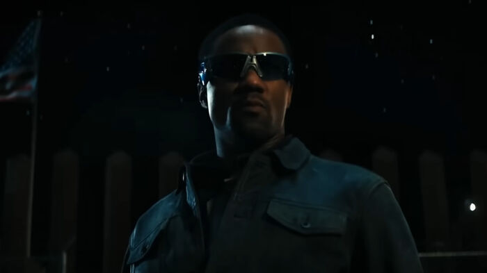 A-Train from The Boys Season 5 wearing dark sunglasses and jacket in a nighttime outdoor scene.