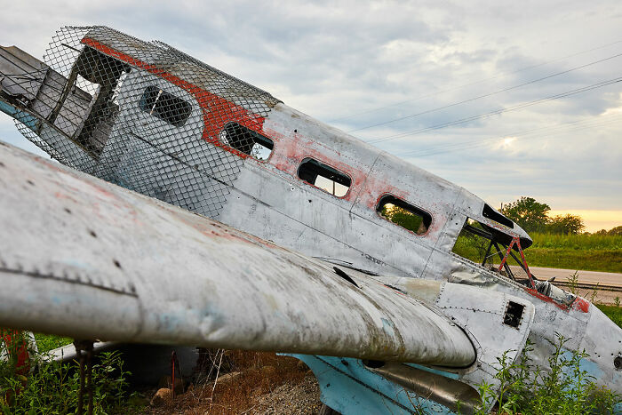Wrecked airplane abandoned in a field, illustrating the darkest possible turn of being late and accidents.
