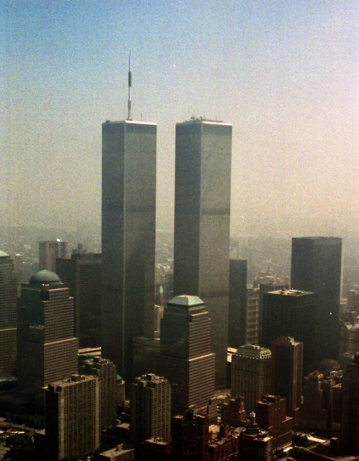 Aerial view of Twin Towers and New York City skyline representing tragic moments when being late took a dark turn.